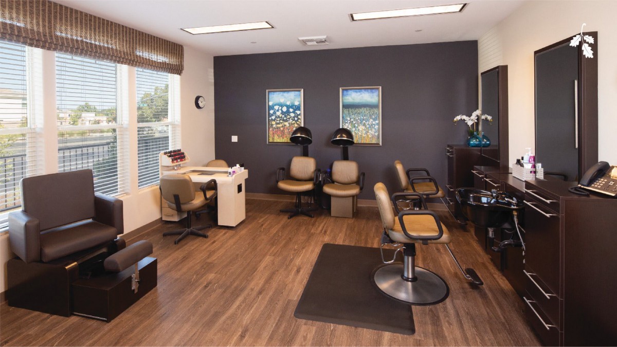 A modern hair salon interior with styling chairs and equipment.