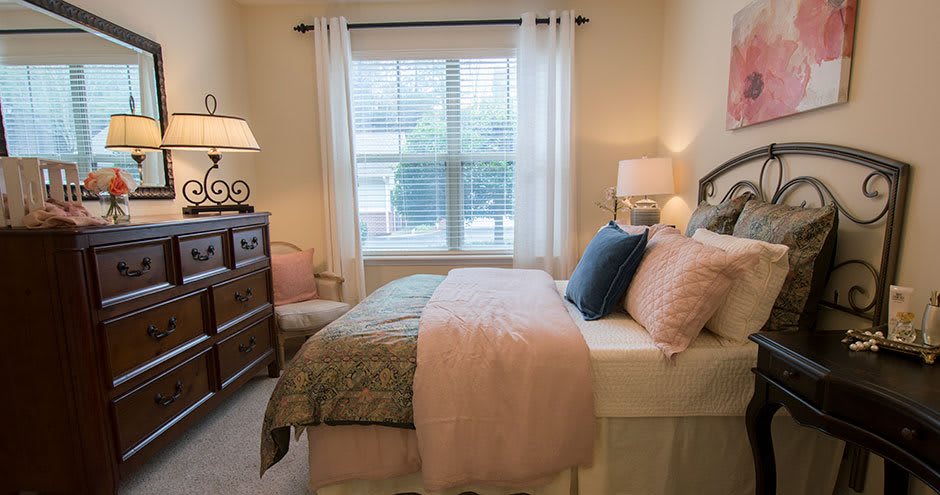 A cozy bedroom with elegant decor and natural lighting.