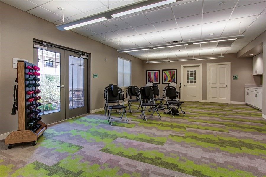 A modern conference room with arranged chairs and colorful carpeting.