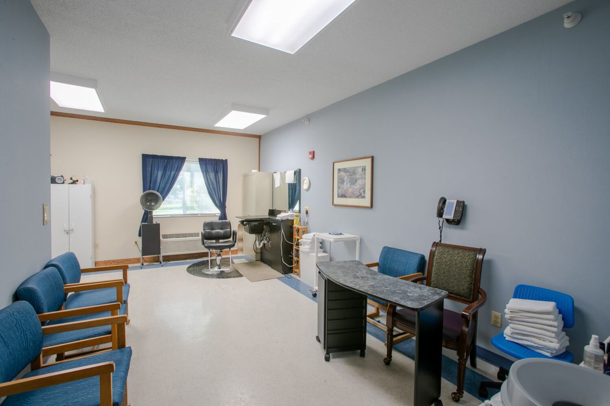 A well-equipped salon interior with chairs and hairdressing stations.