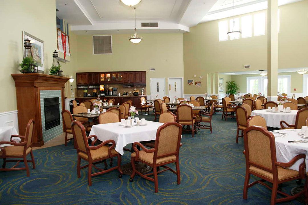 An elegant dining room with neatly arranged tables and chairs.