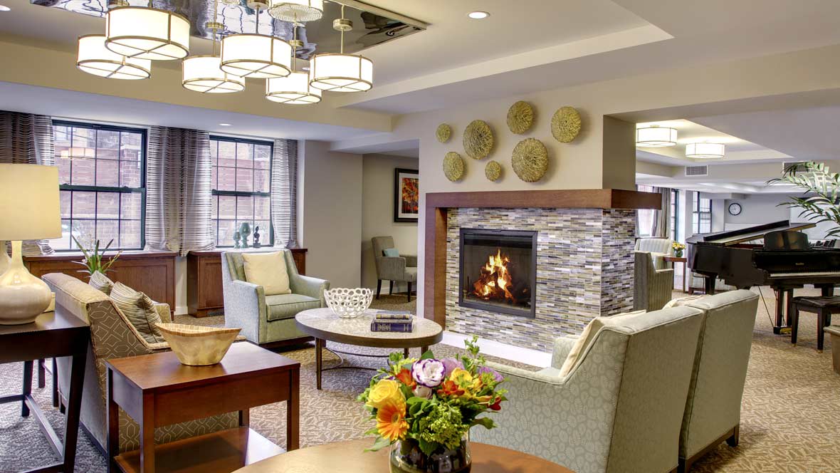 A modern living room with a cozy fireplace, contemporary furniture, and stylish decor.