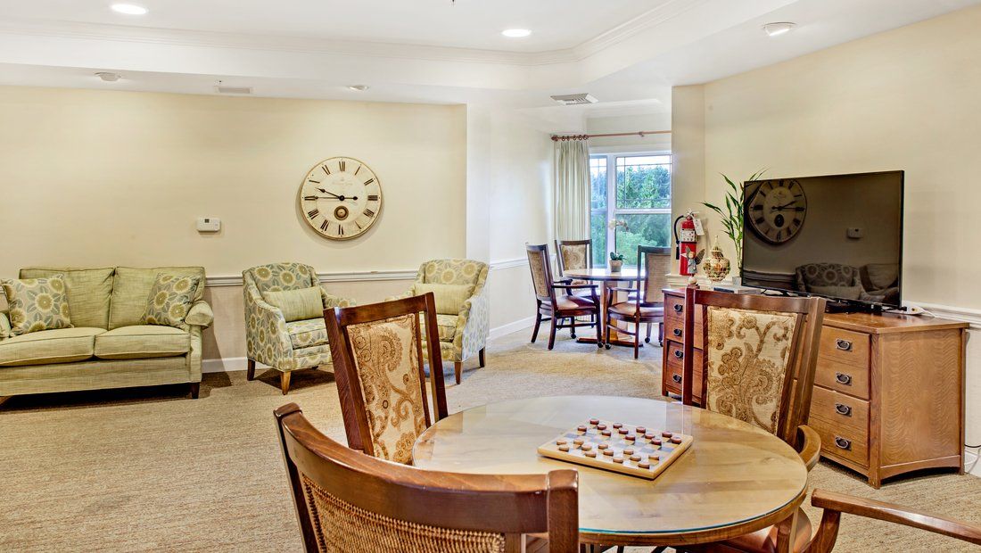 A well-lit dining and living area with wooden furniture and decor.