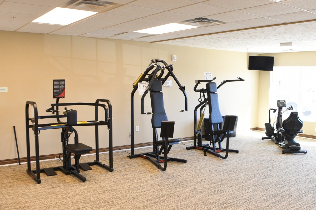 A gym with exercise machines for fitness and workouts.
