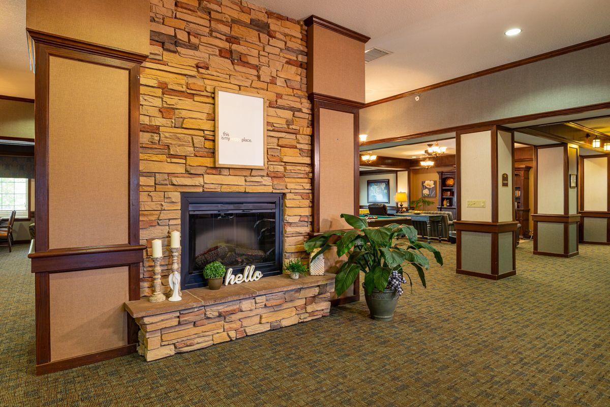 A cozy indoor space featuring a stone fireplace and warm decor.