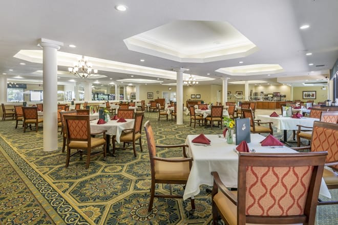 An elegant restaurant dining area with tables and chairs neatly arranged.