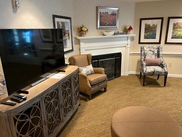 A cozy living room featuring a television, fireplace, and comfortable seating.