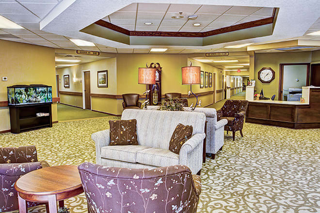 A comfortable lobby with sofas, armchairs, and warm lighting.