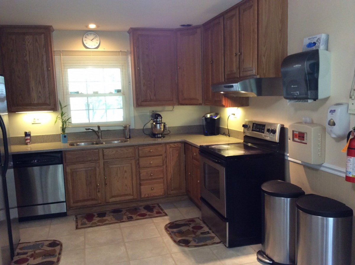 A modern kitchen with wooden cabinets and stainless steel appliances.