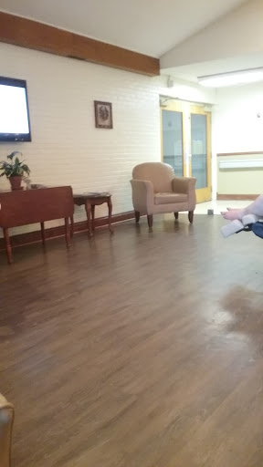 A quiet waiting area featuring a chair and a small table.
