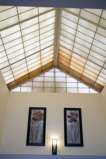 A beautifully designed interior featuring a skylight and decorative wall art.