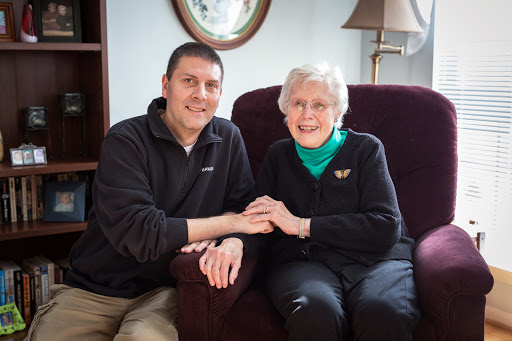 A heartwarming moment between a man and an elderly woman, showcasing their bond.