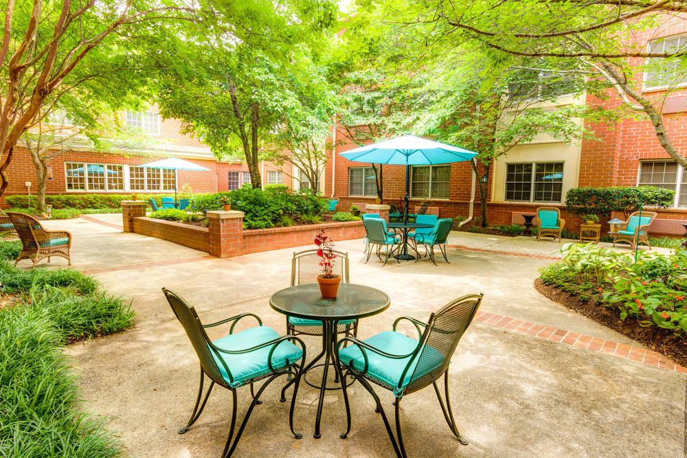 A charming courtyard with outdoor seating and lush greenery.