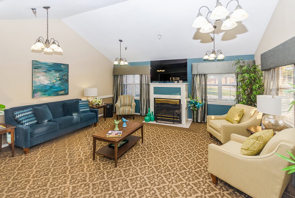 A cozy living room with comfortable seating, a fireplace, and a television.