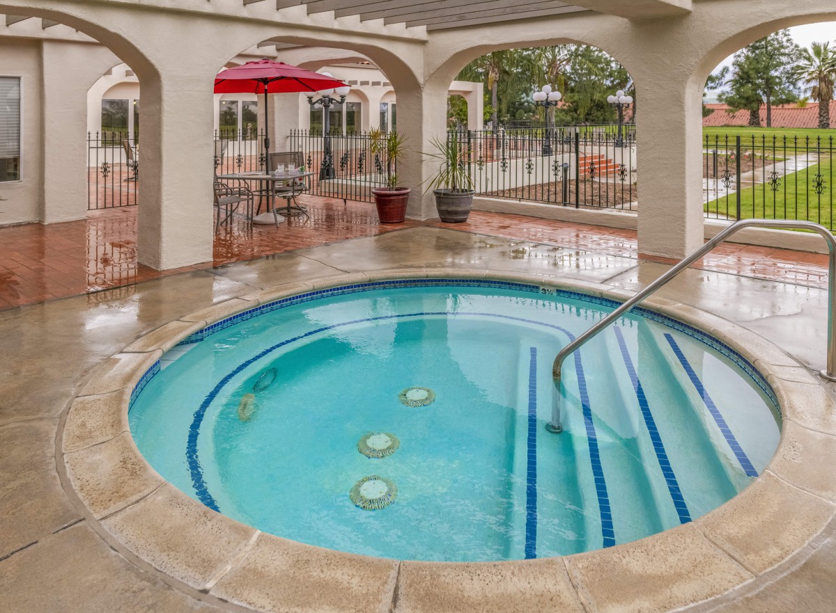 An inviting outdoor hot tub surrounded by a patio for relaxation.