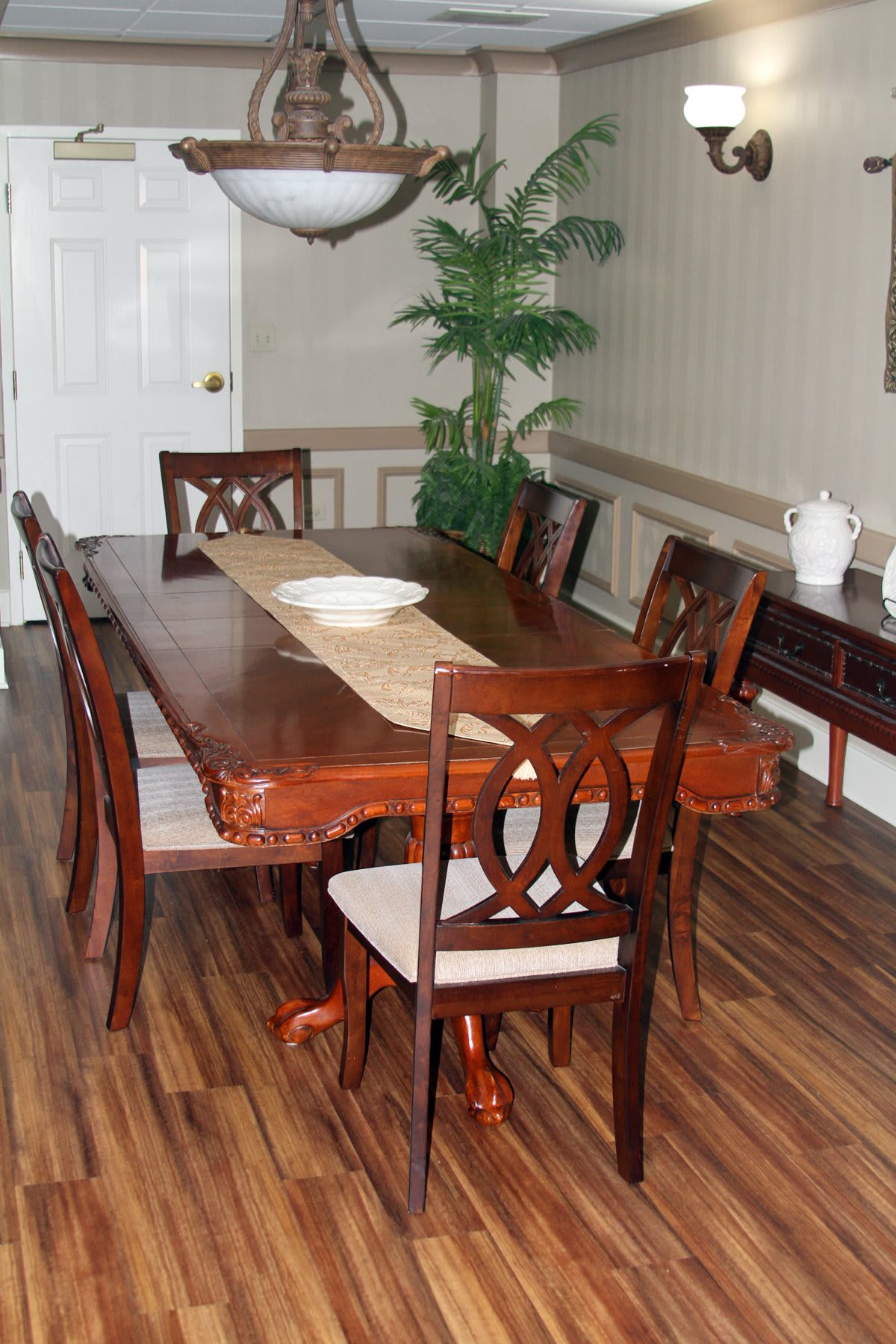 A well-furnished dining room featuring a wooden table and matching chairs.