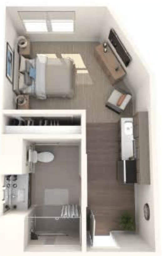 A compact studio apartment floor plan featuring a combined living and bedroom area, adjacent kitchen, and separate bathroom.