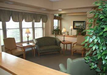 A cozy living room with seating area and warm lighting.