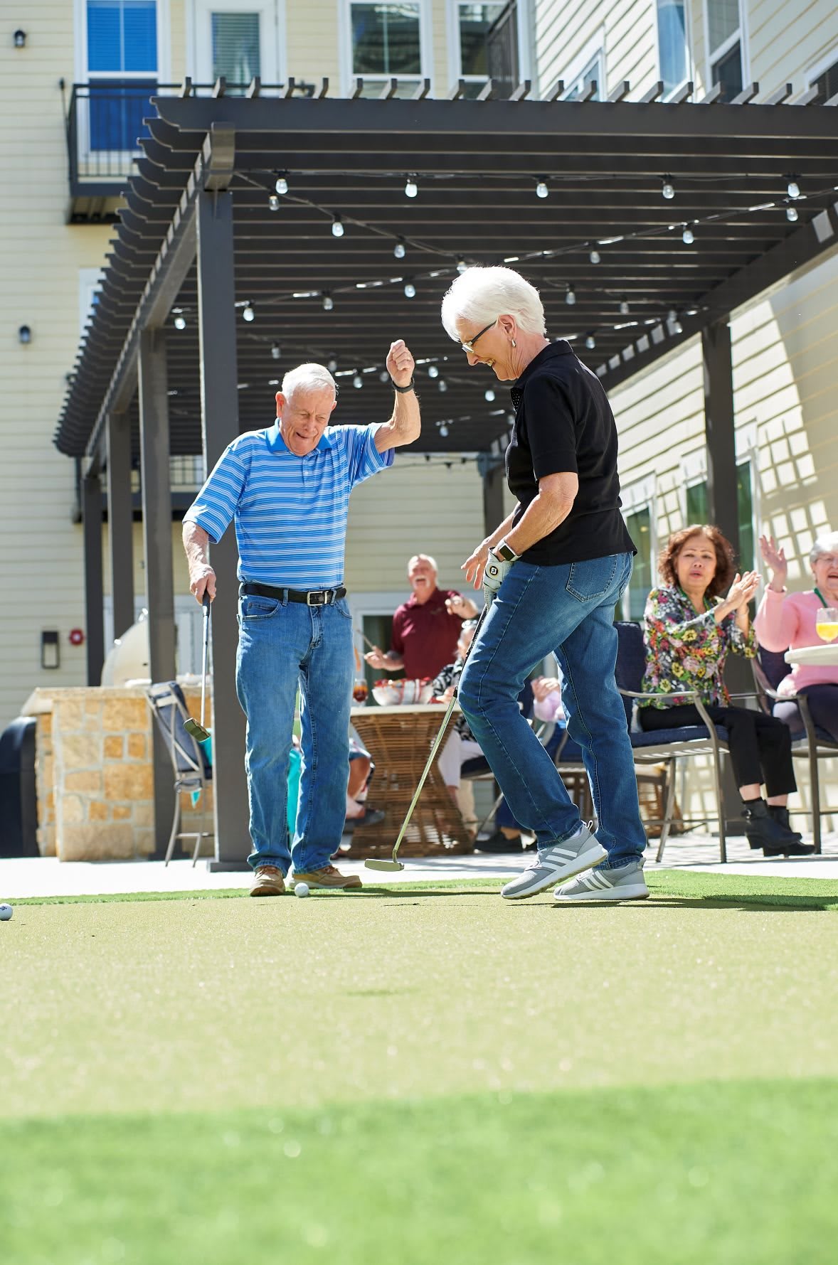 A group of seniors enjoying a dance outdoors during a social gathering.