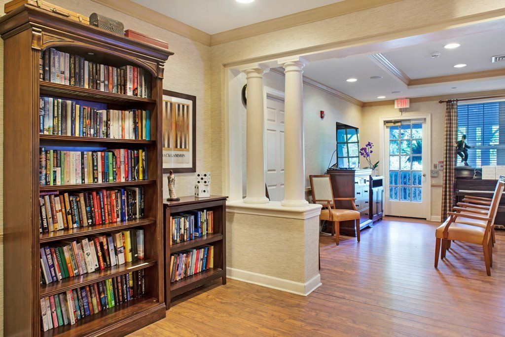 A cozy reading room with a well-stocked bookshelf and comfortable seating.