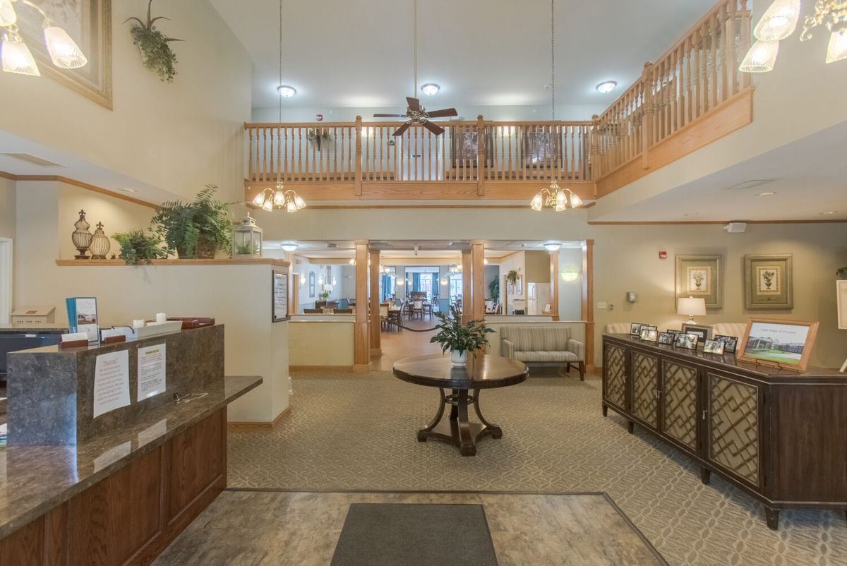 A spacious and elegantly designed lobby area with a high ceiling and luxurious furnishings.