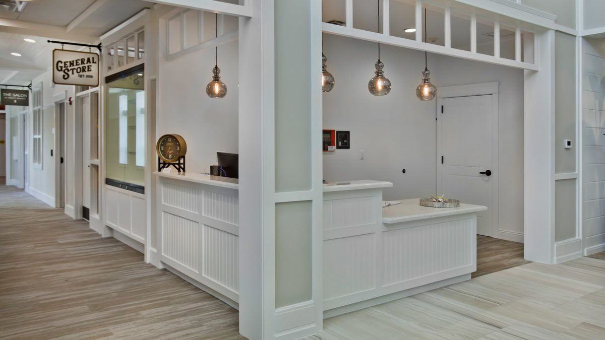 A modern reception area featuring a sleek counter and stylish pendant lighting.