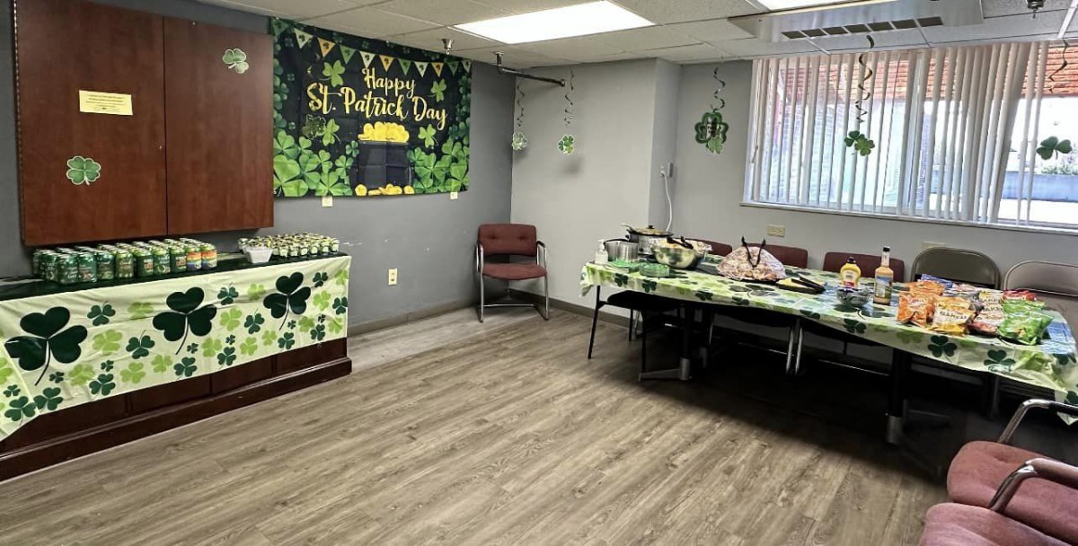 A room decorated for a St. Patrick's Day celebration with green and shamrock-themed decorations.