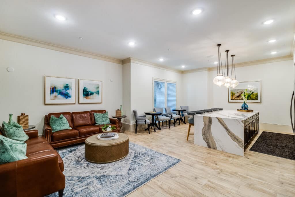 A modern open-concept living space featuring a cozy seating area, stylish kitchen island, and elegant dining setup.