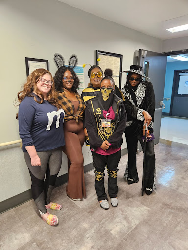 A fun gathering of friends dressed in creative costumes, sharing smiles and good times.