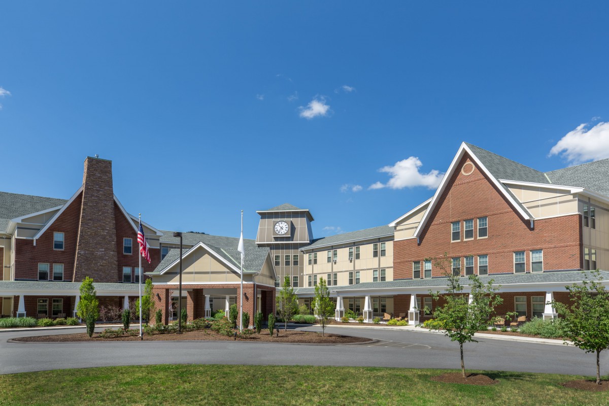 A large hotel building with a clock tower under a clear blue sky.