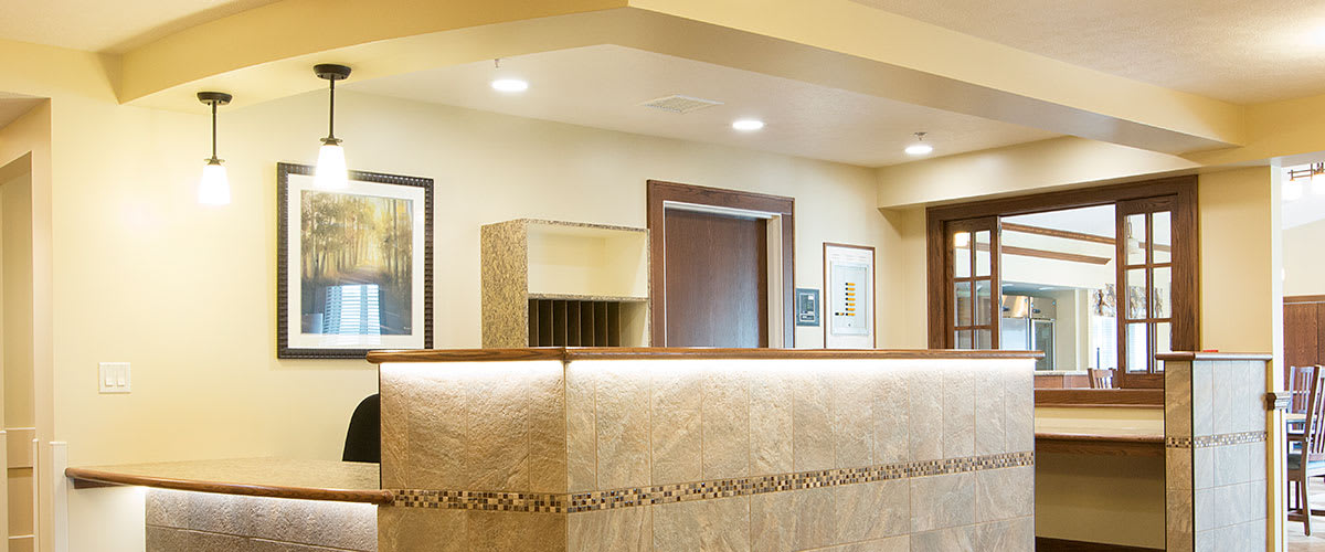 A modern reception area with a sleek front desk and tasteful artwork on the walls.