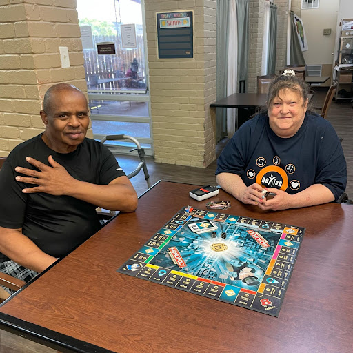 Two friends enjoying a puzzle game together in a relaxed indoor setting.