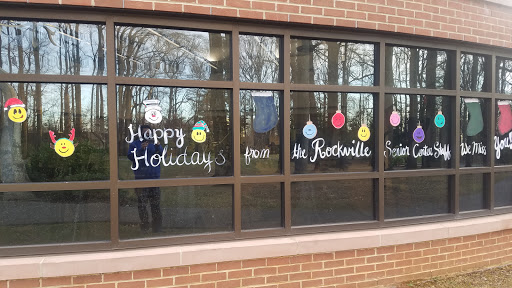 Festive holiday greetings displayed on windows, spreading cheer in the community.