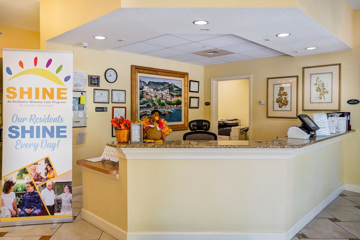 A welcoming reception area with a desk and colorful artwork on the walls.
