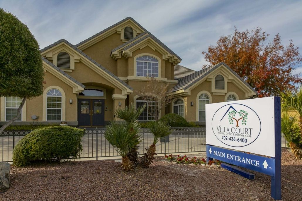 A beautiful residential home with a real estate sign in front.