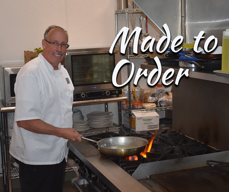 A chef preparing a dish in a restaurant kitchen with the caption 'Made to Order'.