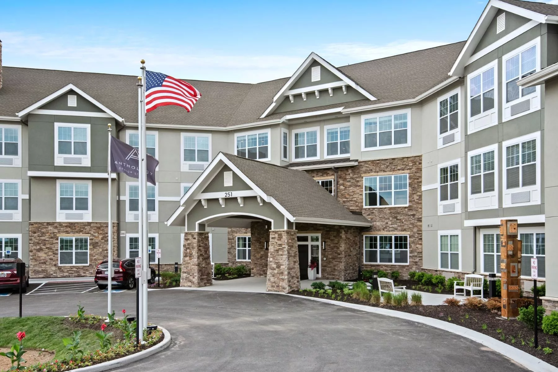 A residential building with a flagpole and entrance area.