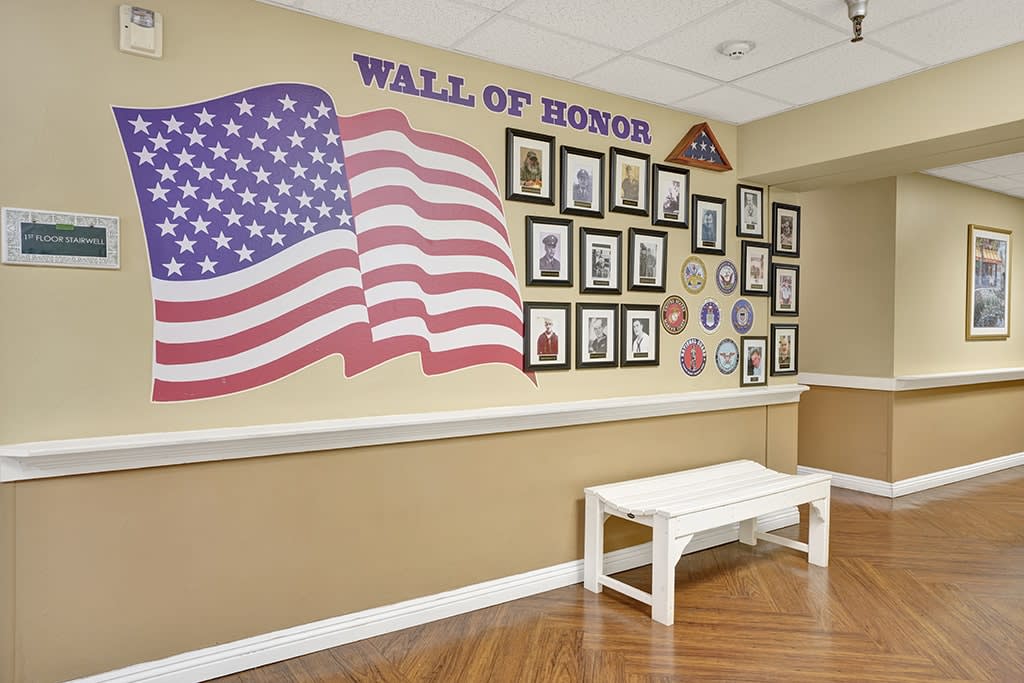 A Wall of Honor featuring the American flag and photographs of veterans in a commemorative display.