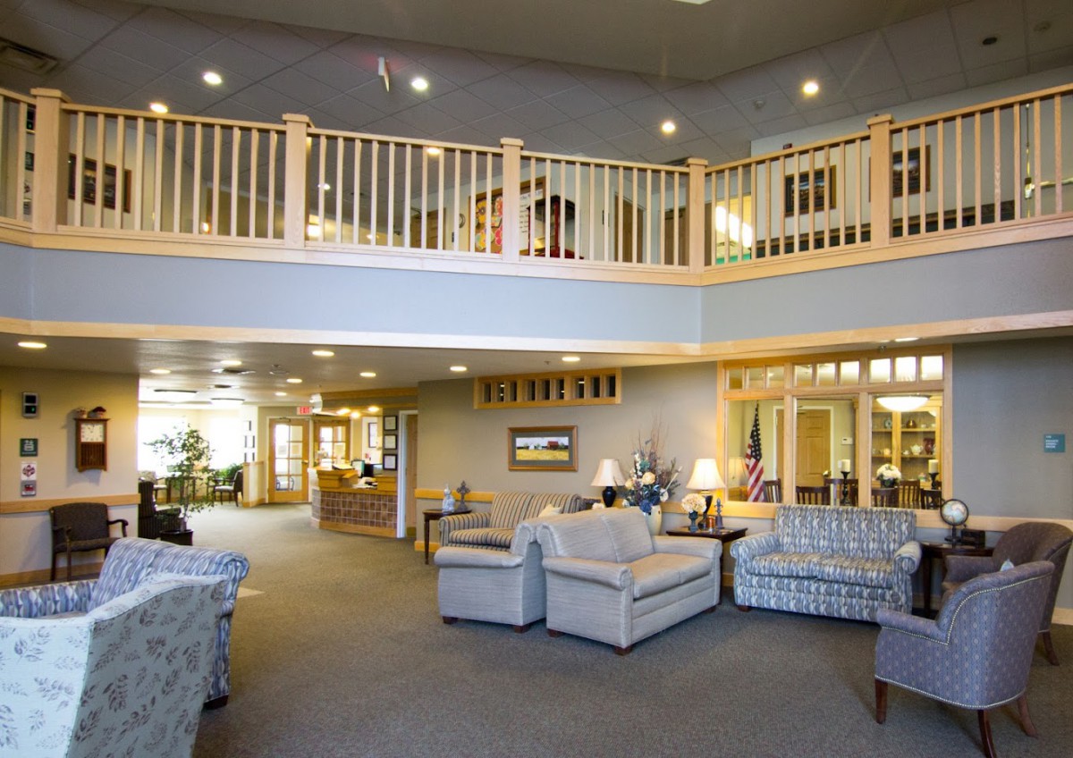 A spacious lobby with comfortable seating and a balcony overlooking the area.