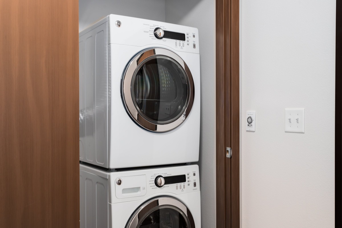 Stacked washer and dryer unit in a home interior.