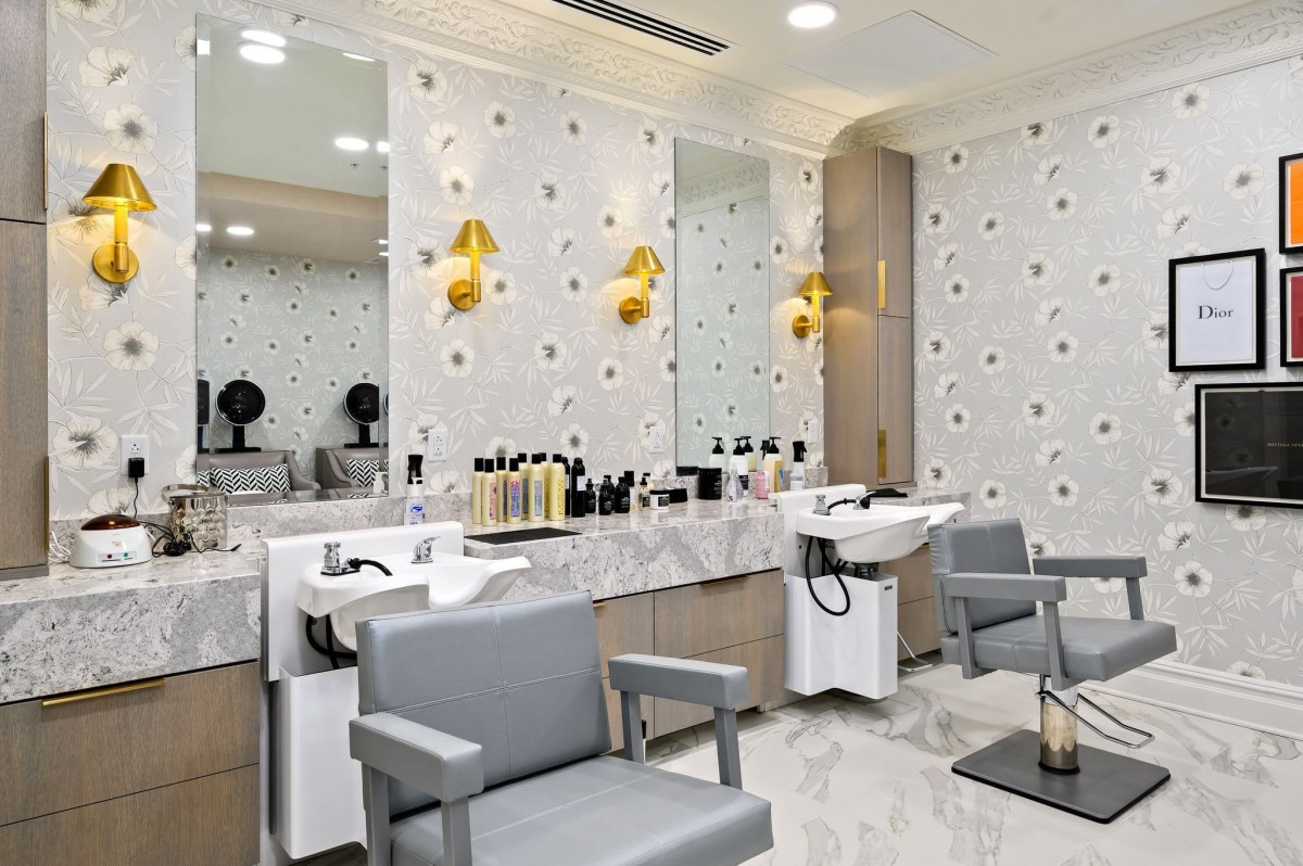 A modern hair salon interior with stylish seating and washing stations.