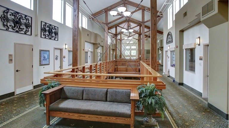 A spacious lobby featuring modern wood architecture and natural lighting.