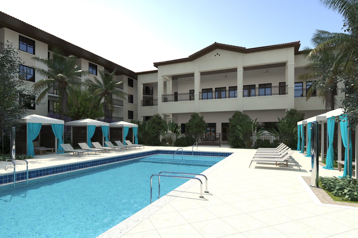 A luxury resort with a large swimming pool and stylish outdoor amenities under a clear blue sky.