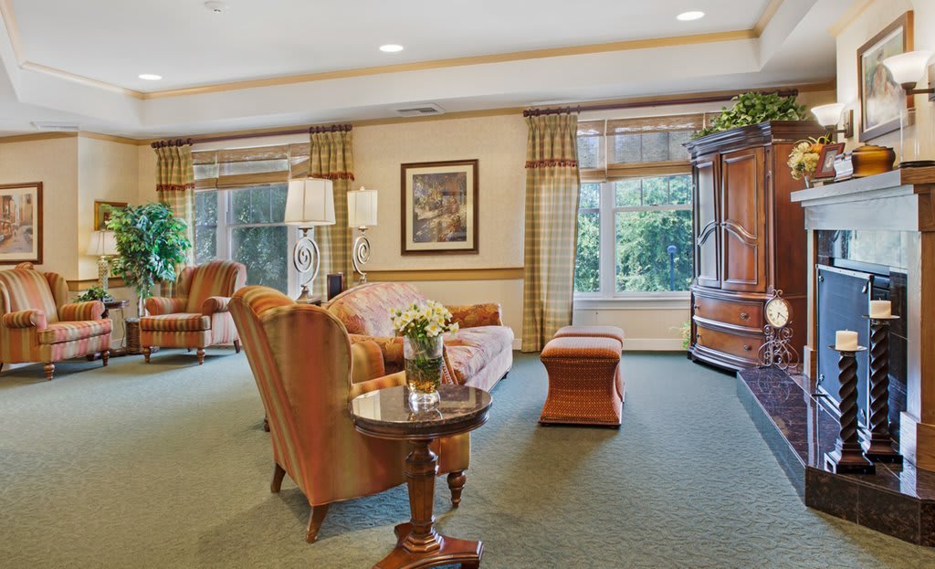 A cozy, spacious living room with elegant furniture and large windows.