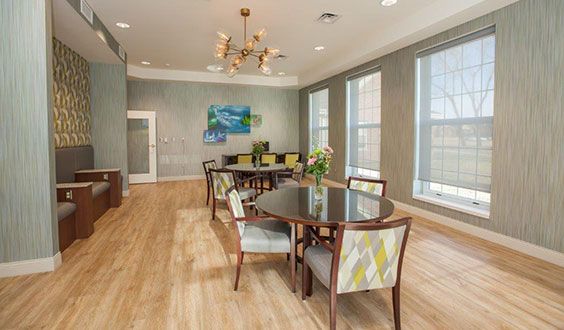 A stylish dining room with contemporary decor and large windows.