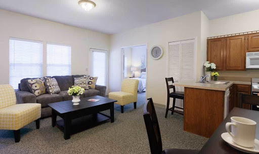A cozy and modern living room in an apartment, featuring a comfortable sofa, coffee table, and seating area.