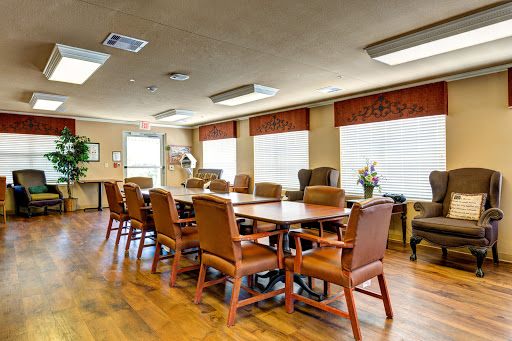A spacious conference room equipped with a large table and comfortable chairs, ideal for meetings and discussions.