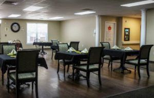 An empty dining room with tables and chairs arranged neatly.