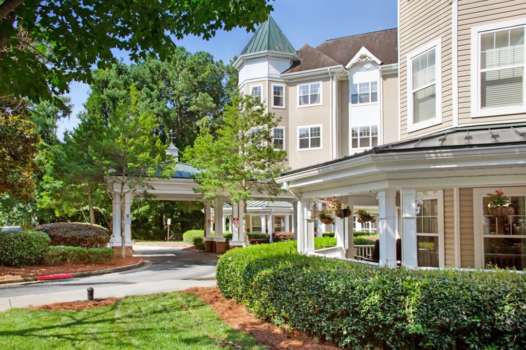 A residential building with well-maintained landscaping and a covered entrance.
