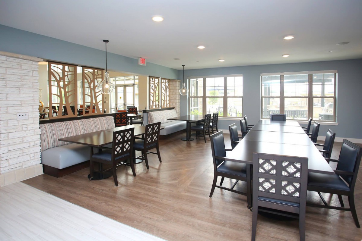 A spacious dining room with elegant furniture and large windows.